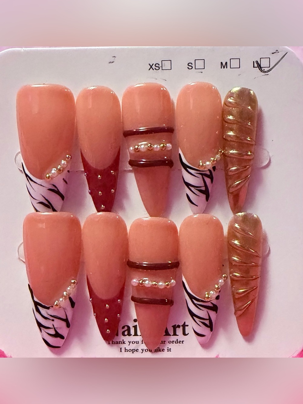 Peach Pink Press-On Nails with Gold Accent & Black Swirl Design